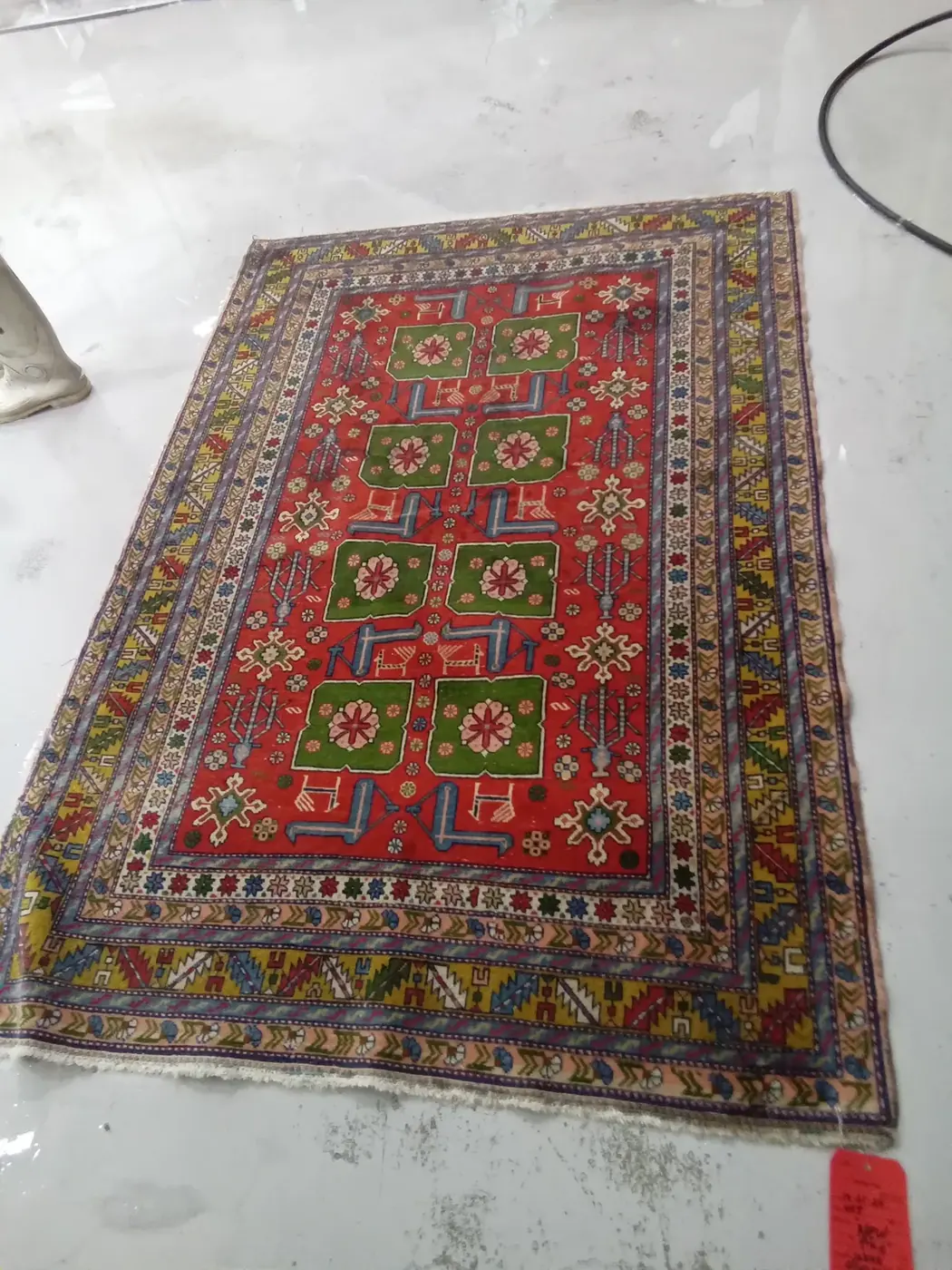 Colourful tribal Kazak rug shown full after cleaning
